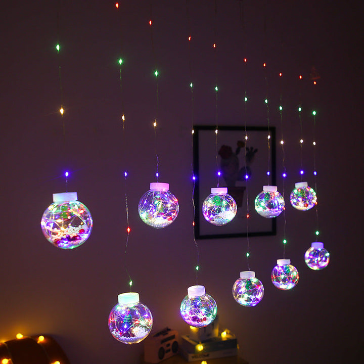 Lichtgordijn met kerstballen en kerstfiguren